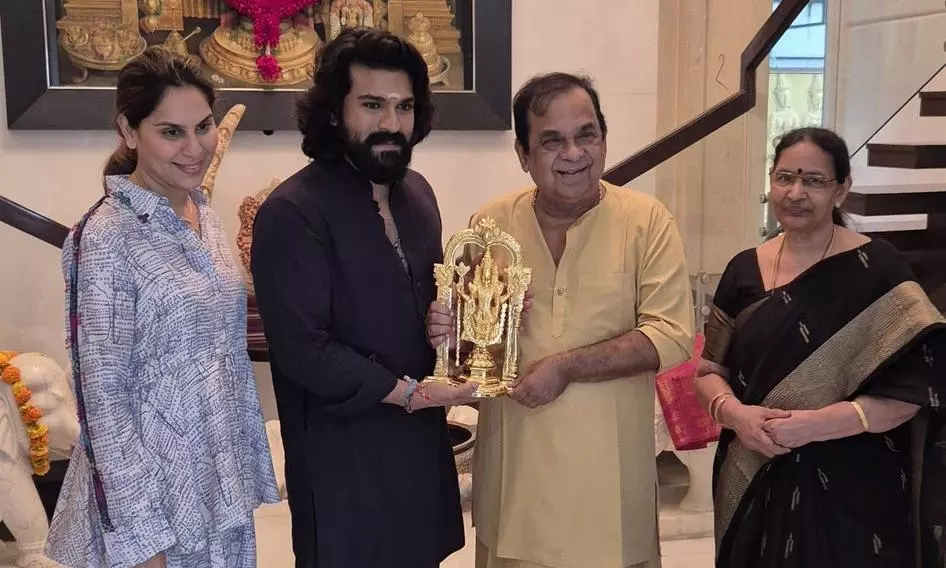 Ram Charan Gifts Golden Idol to Brahmanandam