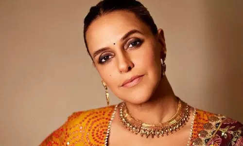 Neha Dhupia Shines In Radiant Orange Saree