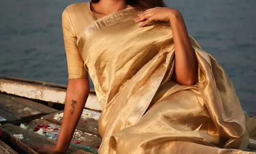 Esha Guptas Timeless Beauty Shines in Exquisite Gold Silk Saree