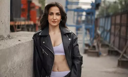 Confidence Queen Elli Avram Rocks the Unbuttoned Trend