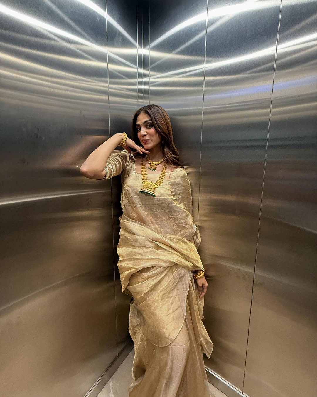 Malavika Mohanans Graceful Style in Golden Saree with a Playful Twist