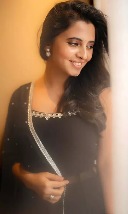 Preethi Asrani Stands by the Window in Black Suit