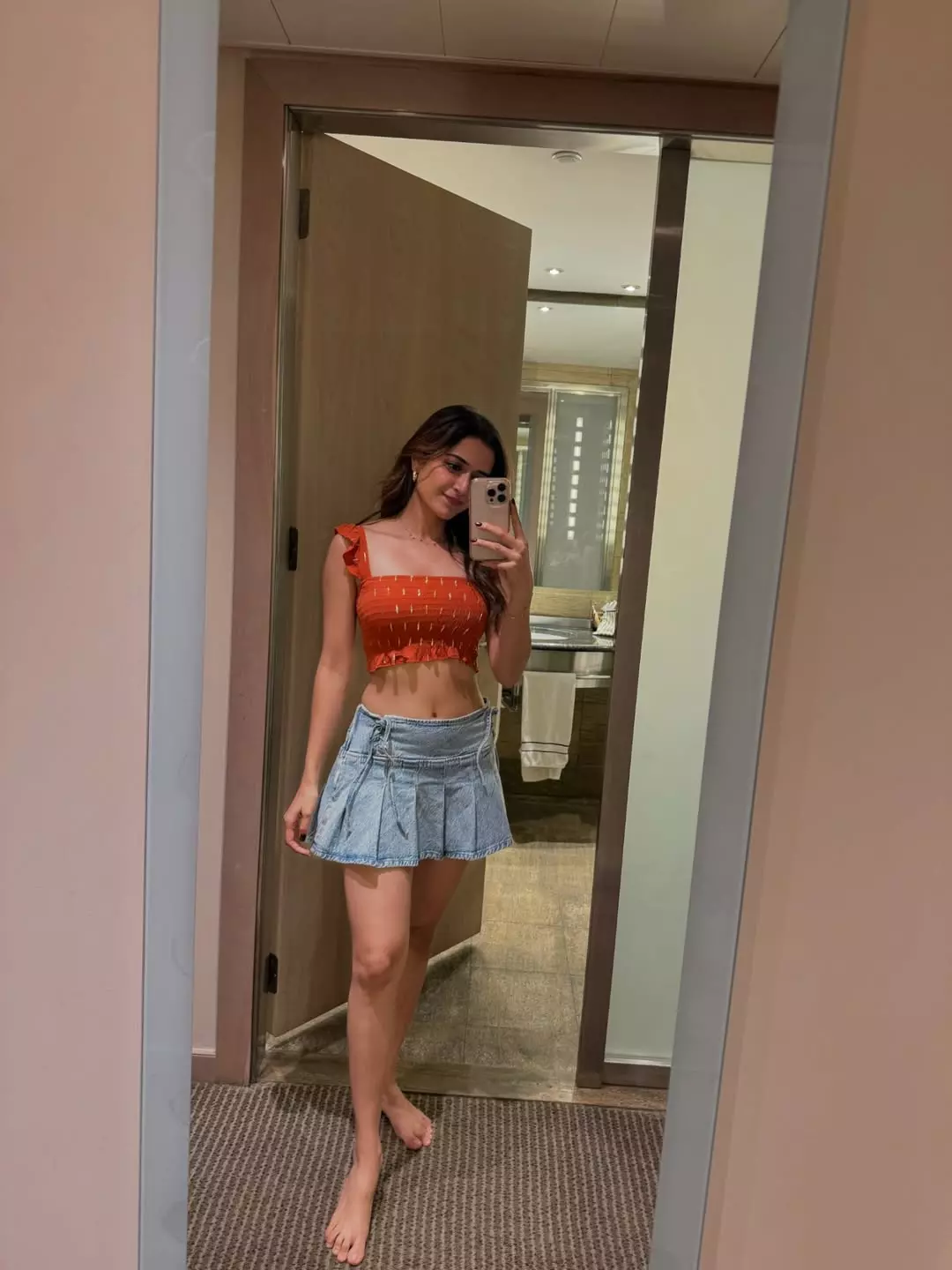 Ashika Ranganath stuns in playful mirror selfie with fiery orange look