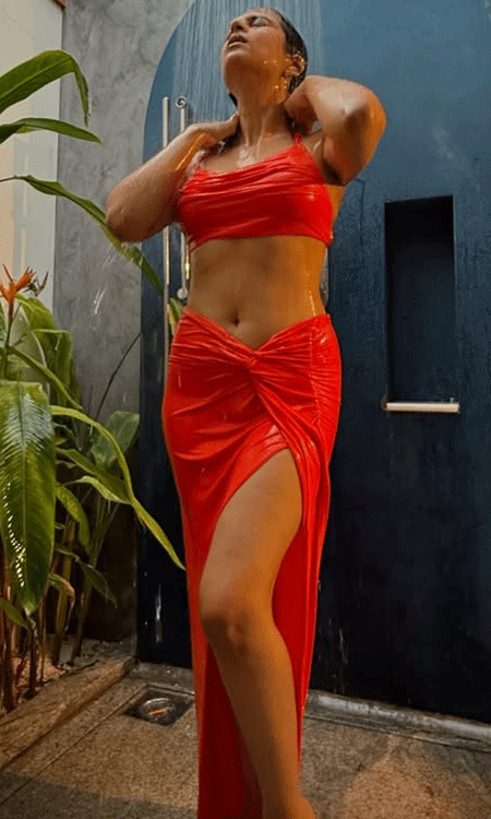 Shraddha Das dazzles in red tropical shower glam