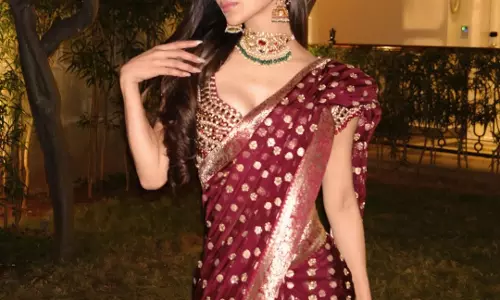 Mouni Roy Glows in Wine-Maroon Banarasi Saree