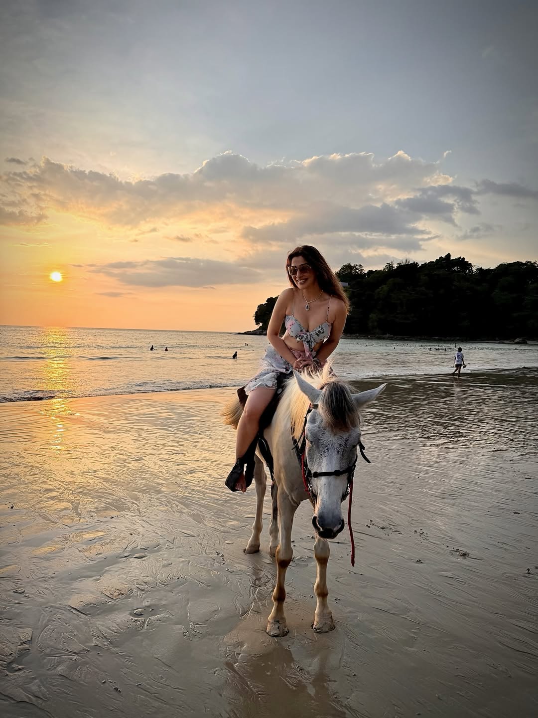 Raai Laxmi Looks Dreamy Riding into a Golden Beach Sunset