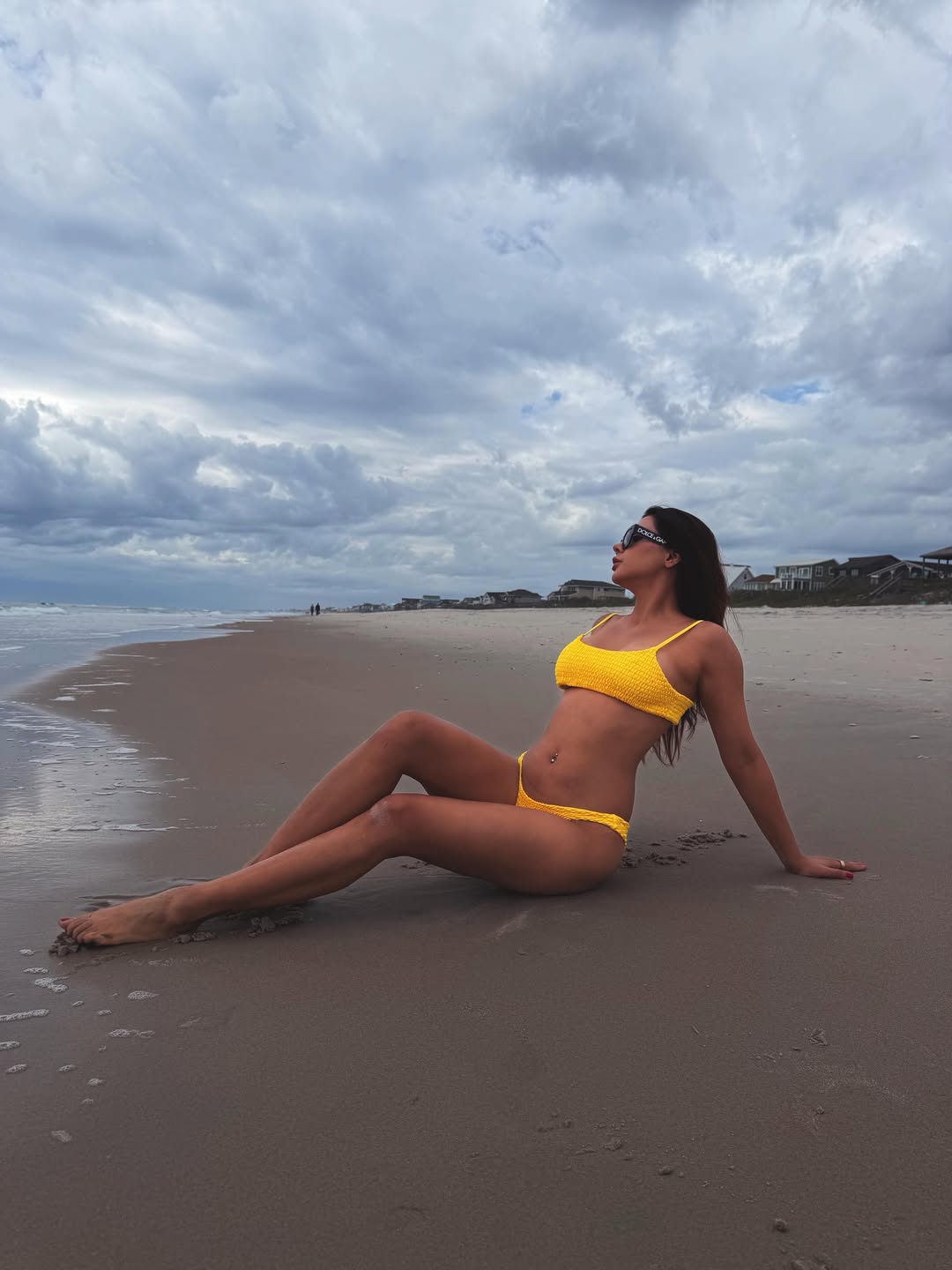 Ruhii Singh Stuns in Yellow Bikini Amid Cloudy Coastal Skies