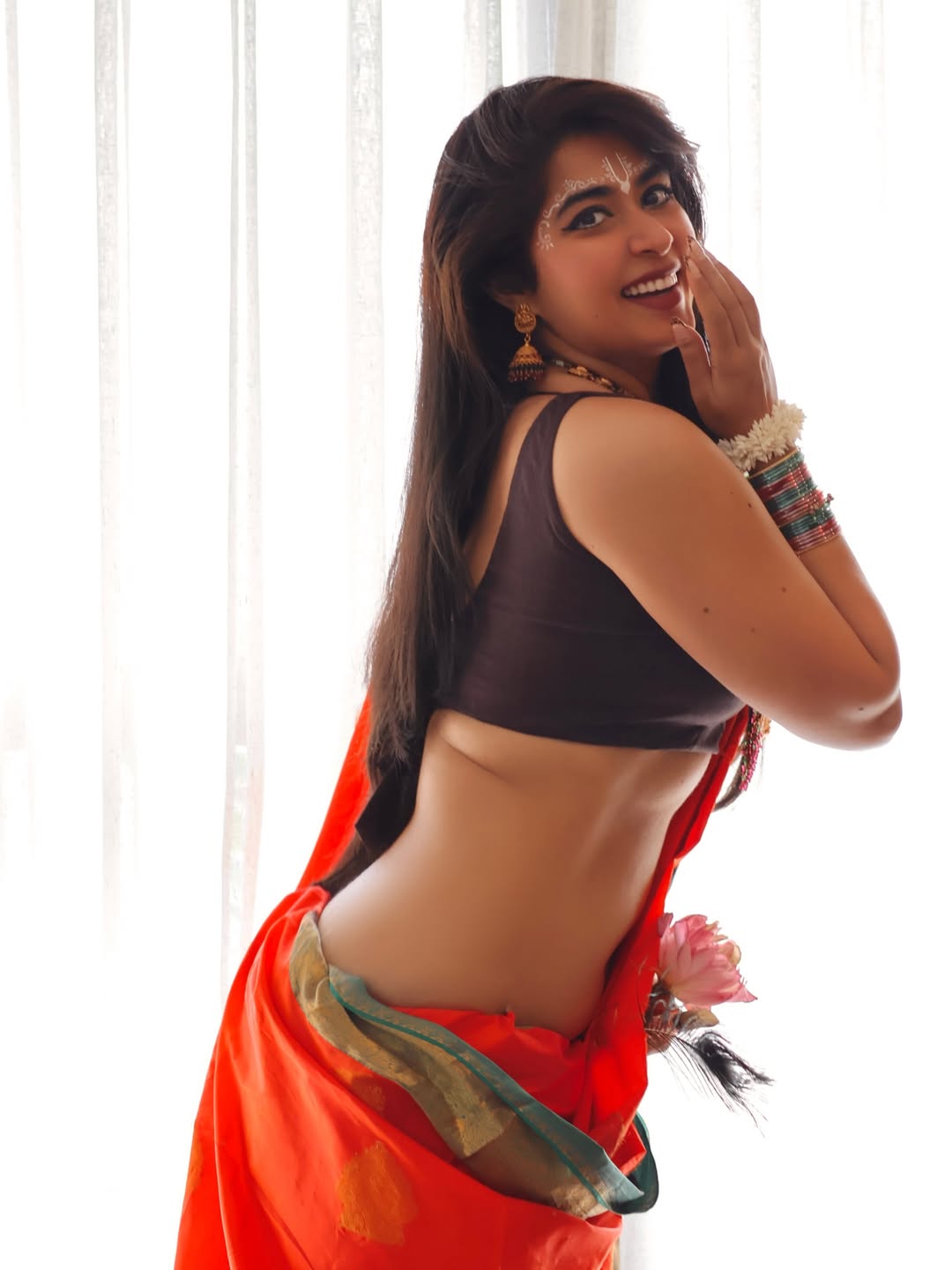 Nikita Sharma Stuns in Traditional Orange Saree for Janmashtami
