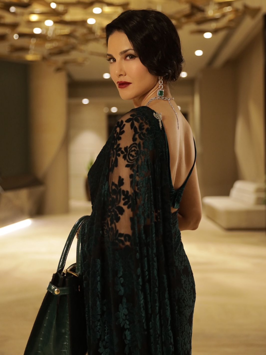 Sunny Leone Stuns in Regal Emerald Green Saree Look