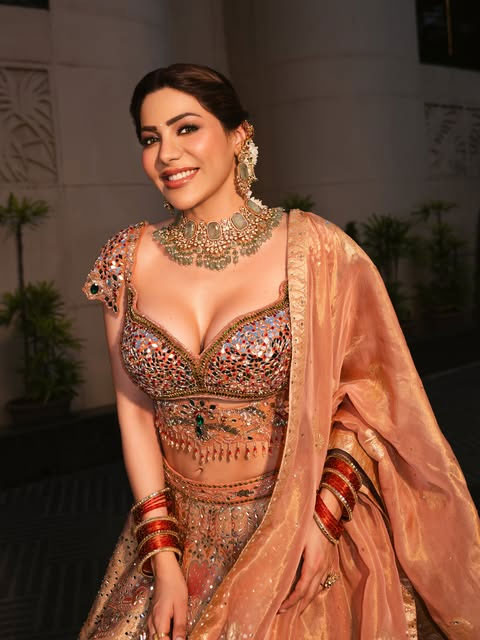 Nikki Tamboli Stuns in Mirror-Work Blouse and Emerald Jewellery