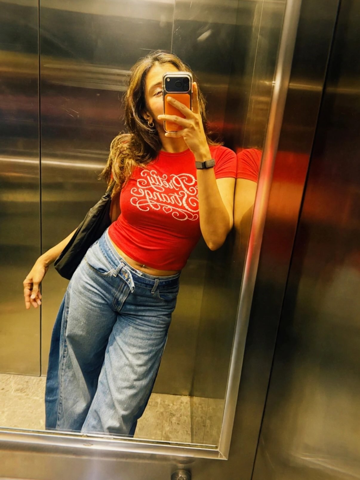 Hebah Patel Stuns in a Red Top and Blue Denim Jeans