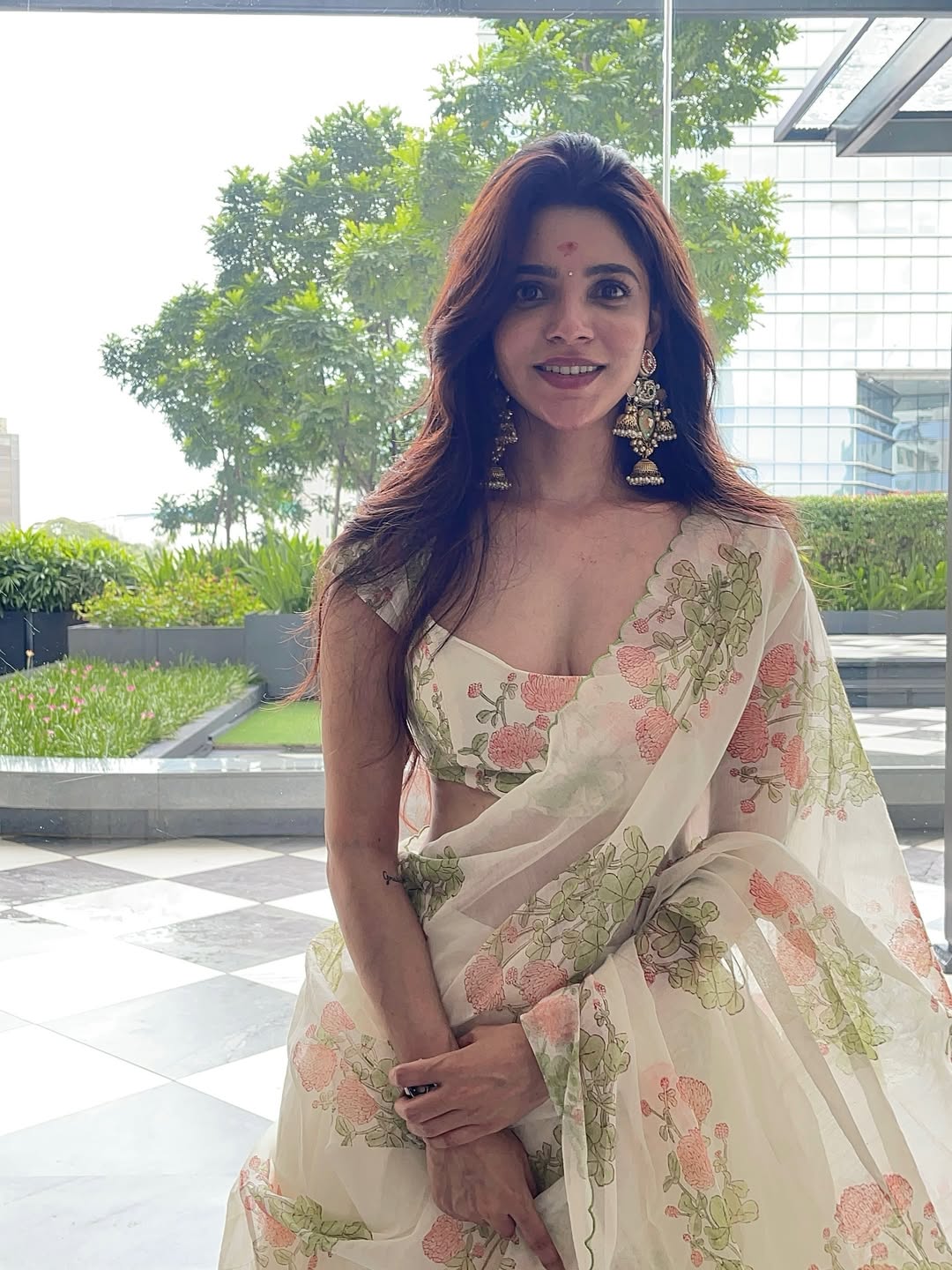 Divya Bharathi Stuns in a White Saree with Floral Prints and Gold Jhumkas