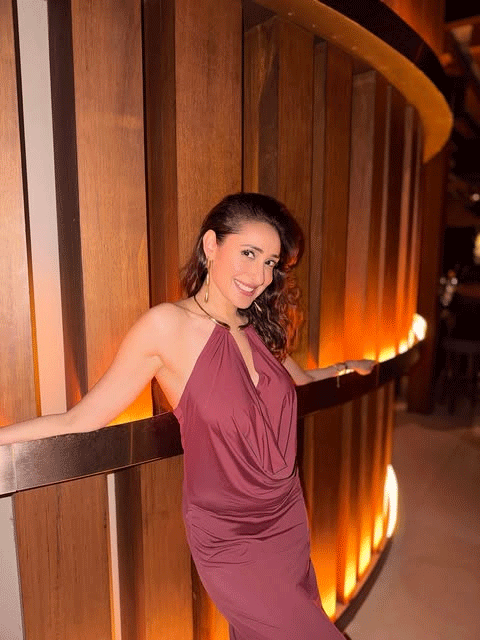 Pragya Jaiswal Stuns in a Rust-Red Halter Maxi Dress at Sunset