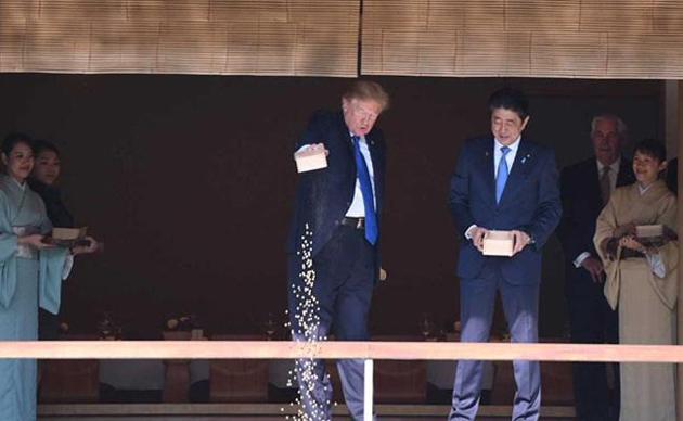 Donald Trump throws Fish Food into Pond